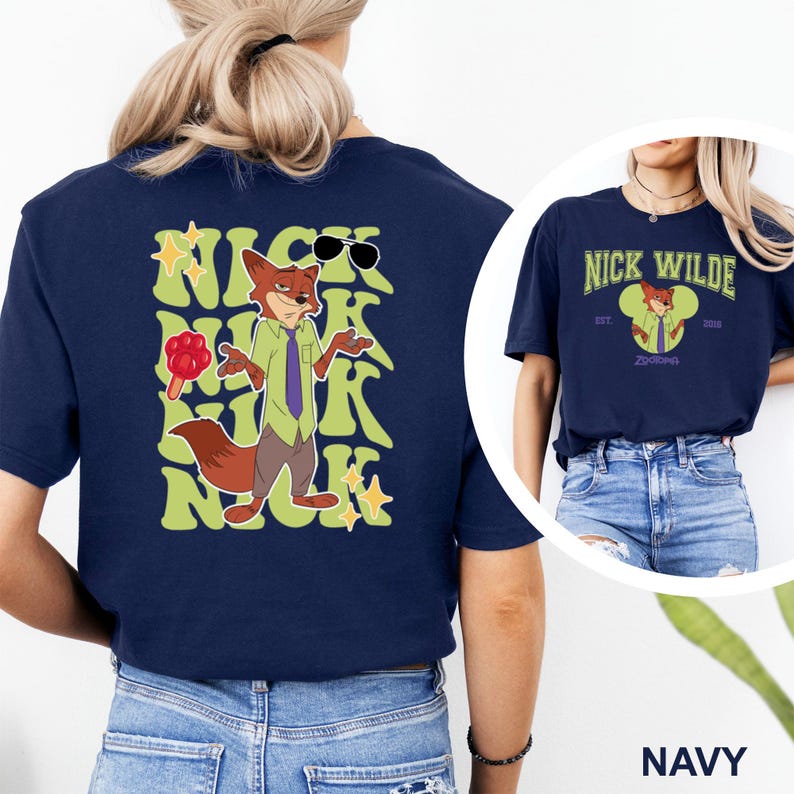 May include: Navy blue t-shirt featuring a cartoon image of Nick Wilde from Zootopia. The design includes Nick wearing sunglasses and a green shirt with a purple tie. The text "Nick Wilde" is also displayed on the shirt.