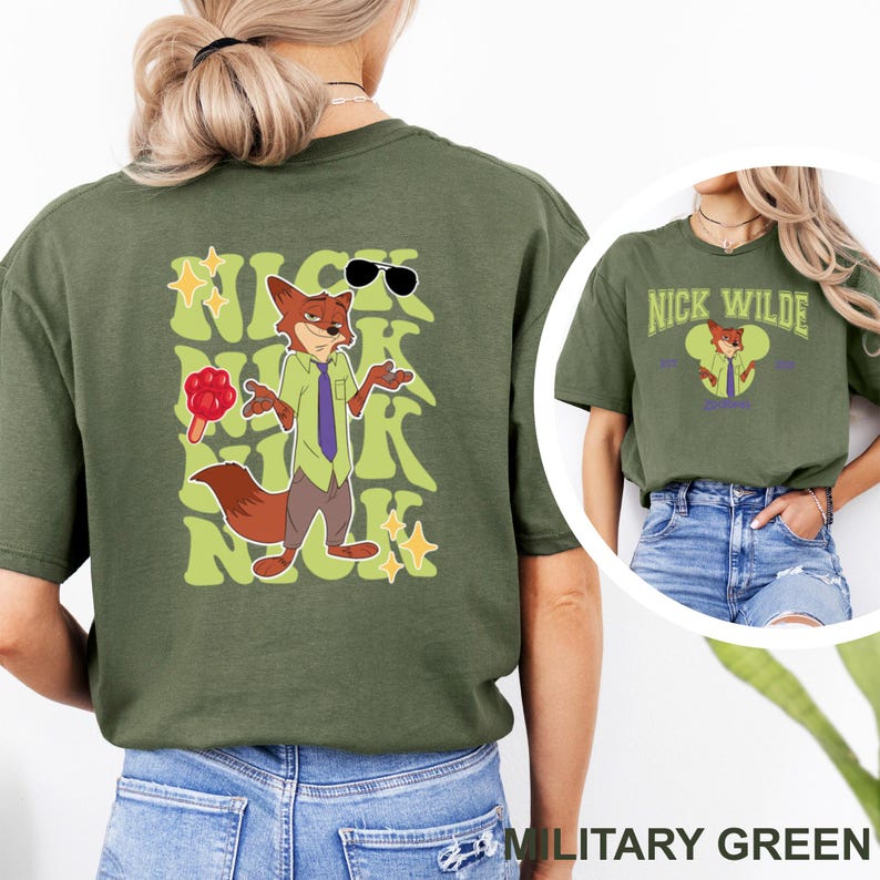 May include: Military green t-shirt featuring a cartoon fox character with sunglasses, a tie, and a lollipop. The back of the shirt has the character's name in a retro font. The front of the shirt has the character's name and image.