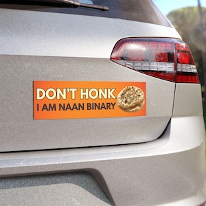 May include: A rectangular orange bumper sticker with a gradient background featuring the text "DON'T HONK I AM NAAN BINARY" in bold white and black lettering, accompanied by a realistic illustration of a piece of naan bread on the right side.