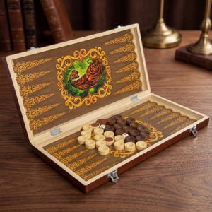 May include: Open backgammon board with a tiger illustration. The wooden board is brown with decorative gold accents and a tiger illustration in the center. The game pieces are brown and white, with dice visible.