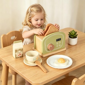 May include: A child's wooden breakfast toy set featuring a green and wood-toned toaster with toast, a milk carton, a cup and saucer, a spoon, and a plate with a toy egg. A small plant in a white pot is also on the table. The set is designed for play.