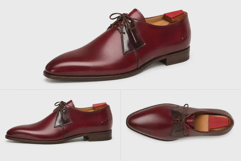 May include: A burgundy leather derby shoe featuring a smooth finish, dark brown laces, and a contrasting dark brown leather panel at the eyelets. The shoe includes a low stacked heel, a pointed toe, and a wooden shoe tree with a red heel insert.