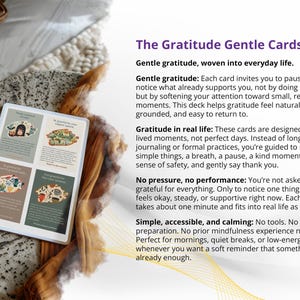 May include: A deck of "The Gratitude Gentle Cards" with four illustrated cards visible. The cards are on a white background, with text describing gratitude practices. The cards are on a textured surface.