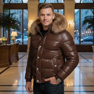 May include: A brown leather puffer jacket with a fur-trimmed hood. The jacket features a glossy finish, button closures, and side pockets. The model is wearing a watch and dark blue jeans.