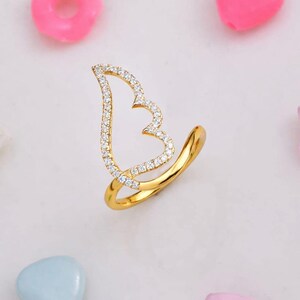 Two-tone 925 silver and gold CZ angel wing ring with a pavé silver wing on a slender band; perfect gift for her.