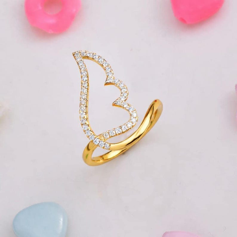 Two-tone 925 silver and gold CZ angel wing ring with a pavé silver wing on a slender band; perfect gift for her.