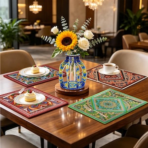May include: A wooden dining table set with four rectangular placemats featuring intricate, colorful geometric and floral patterns. A central blue and yellow decorative vase holds a bouquet of a large sunflower and white roses.