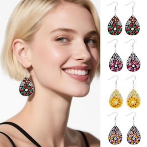 May include: Teardrop-shaped earrings with colorful jewel-like accents. The earrings feature a floral design with red, green, and white gems. Additional pairs in purple, yellow, and a mix of purple and yellow are also shown. The earrings are displayed on a white background.
