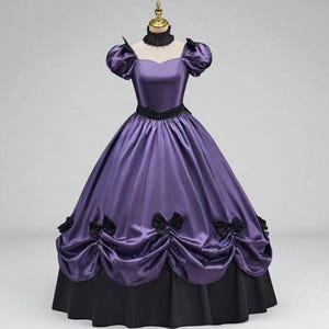 May include: A Victorian-style gown in shades of purple and black. The dress features a fitted bodice with a sweetheart neckline, short puffed sleeves, and a black choker. The full skirt is gathered and adorned with black bows, transitioning to a black hem.