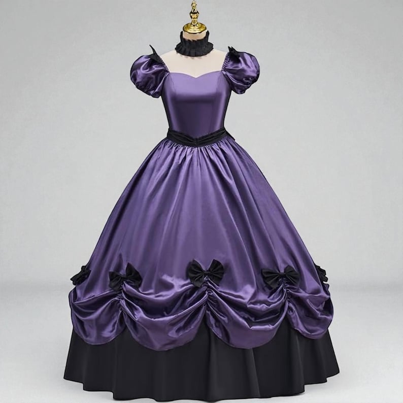 May include: A Victorian-style gown in shades of purple and black. The dress features a fitted bodice with a sweetheart neckline, short puffed sleeves, and a black choker. The full skirt is gathered and adorned with black bows, transitioning to a black hem.