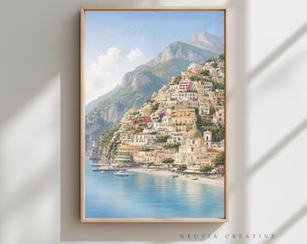 May include: A framed print of a coastal town nestled on a hillside, featuring colorful buildings, a church with a dome, and boats on the water. The artwork is in a wooden frame, with the text "NEUVIA CREATIVE" at the bottom.