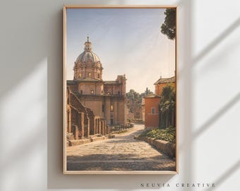 May include: Framed print of a European cityscape featuring a domed building and a cobblestone street. The artwork has a warm color palette with a golden frame. The text "NEUVIA CREATIVE" is at the bottom.