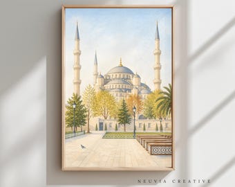 May include: Watercolor painting of the Blue Mosque in Istanbul, Turkey, set in a wooden frame. The artwork depicts the mosque with its iconic domes and minarets, surrounded by trees and a paved courtyard. The sky is a soft blue.