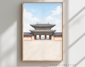 May include: Framed print of a traditional Korean palace gate under a blue sky with scattered clouds. The architecture features a multi-tiered roof and red and white walls. The print is in a light wooden frame.