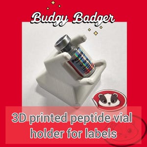 May include: A white 3D printed vial holder cradling a small glass peptide vial with a silver cap and a holographic label reading Peptide 5/5mg. The text Budgy Badger appears at the top, and a small badger sticker is placed near the holder base.