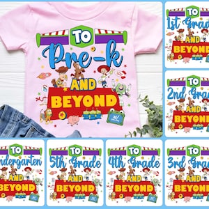 May include: A light pink short-sleeve t-shirt featuring a colorful graphic print with the text "TO Pre-k AND BEYOND" and various cartoon characters including a cowboy, a cowgirl, a space ranger, and other toys, surrounded by small stars.