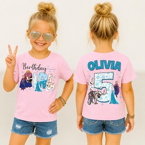 May include: Pink short-sleeved t-shirt with a graphic featuring characters and text from the movie Frozen. The front says "Birthday Girl" and the back says "Olivia 5". The girl is wearing denim shorts.