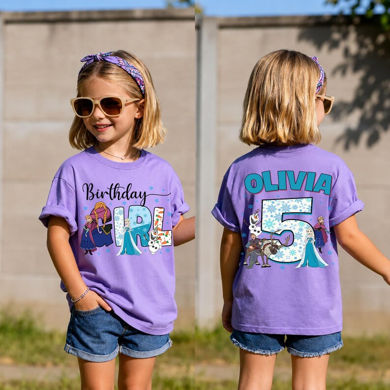 May include: A purple t-shirt with the words "Birthday Girl" and a graphic of animated characters. The back of the shirt has the name "Olivia" and the number "5" with more graphics. The girl is wearing denim shorts and sunglasses.