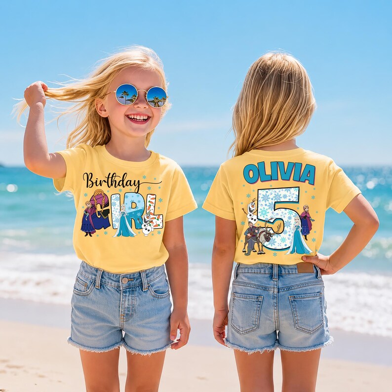 May include: Two yellow t-shirts with a birthday theme. The front of the shirt says "Birthday Girl" with cartoon characters. The back of the shirt says "Olivia 5" with cartoon characters. The girls are wearing blue jean shorts and sunglasses.