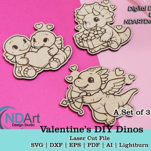 May include: Three wooden laser-cut dinosaur designs on a pink background. One design shows two dinosaurs holding a heart, another a dinosaur with a basket of hearts, and the last a winged dinosaur with a bow and arrow. Text reads "Valentine's DIY Dinos".