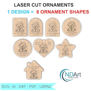 May include: Seven light-colored wooden laser-cut ornaments in various shapes including rectangle, circle, heart, star, and house. Each ornament features an engraved teddy bear wearing a Santa hat and the text My First Christmas Oliver 2026.