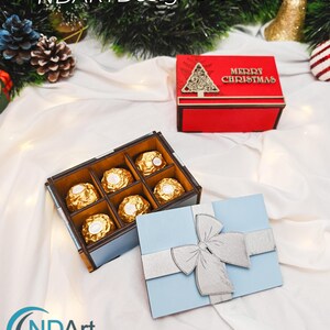 May include: A light blue and brown chocolate box with six gold-wrapped chocolates. A red box with a Christmas tree design and the words "MERRY CHRISTMAS" is also present. A light blue gift box with a silver bow is also visible. The image includes the text "Digital Download by NDARTDesignStudio".