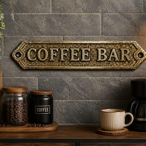 Könnte beinhalten: Ein rechteckiges, metallisches Wand-Schild in Bronzefarbe mit abgeschrägten Kanten und Befestigungslöchern an beiden Enden, das den geprägten Text COFFEE BAR in einer fetten Serifenschrift auf einem texturierten, dunklen Hintergrund zeigt.