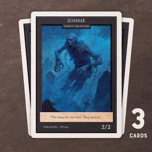 May include: Three collectible cards with a zombie illustration. The cards have a black border with white edges and include the text "ZOMBIE" and "TOKEN CREATURE". The artwork depicts a decaying figure in a blue-toned environment. The cards are labeled "2/2".
