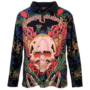 May include: Black long-sleeve collared shirt with a skull graphic. The shirt features a skull with red roses, wings, and the text "Christian Audigier". The shirt has a black collar.