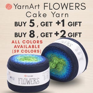 May include: Two cakes of YarnArt Flowers cake yarn featuring a gradient color transition from dark navy blue to bright blue and lime green. The white paper labels display the brand name, product name, and care instructions in black text.