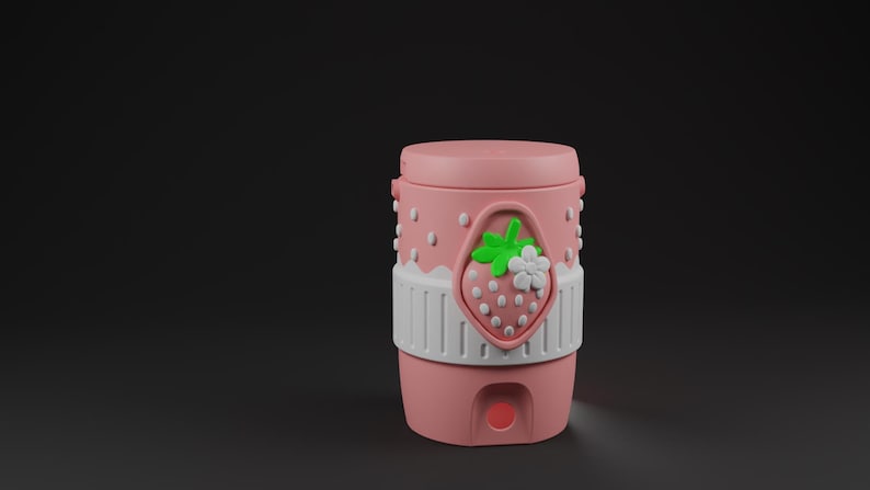 May include: A cylindrical pink container with a lid, featuring a white band around the center and a raised strawberry emblem with green leaves and a white flower. The upper portion of the container has a dotted texture, and a small circular opening is visible at the base.