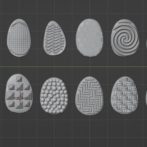 May include: A collection of twenty gray, egg-shaped objects with various surface textures. The designs include stripes, swirls, geometric patterns, and wood grain effects. The eggs are arranged in two rows on a dark gray background.