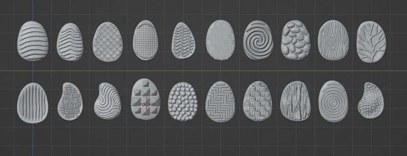 May include: A collection of twenty gray, egg-shaped objects with various surface textures. The designs include stripes, swirls, geometric patterns, and wood grain effects. The eggs are arranged in two rows on a dark gray background.