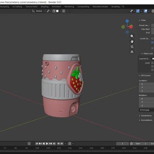 May include: A 3D digital model of a cylindrical pink cup displayed within the Blender software interface. The cup features a textured surface with a strawberry graphic on the side, including green leaves and white flowers against a red background.