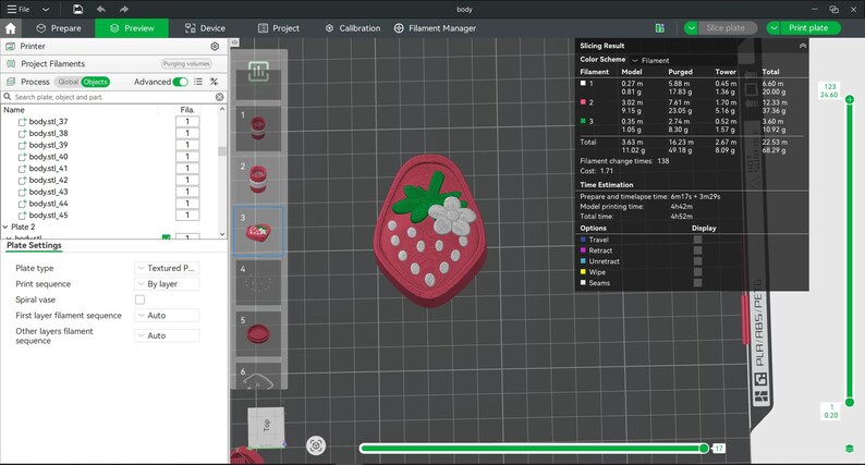 May include: A digital 3D modeling interface displaying a strawberry-shaped object with a pink base, white seeds, green leaves, and a white flower. The software screen shows project filaments, slicing results, and print settings for a 3D printer.