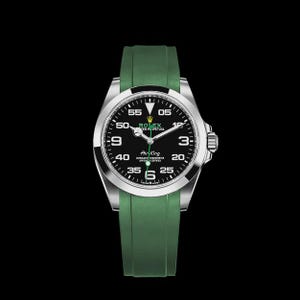 May include: A stainless steel Rolex Air King watch with a black dial and green rubber strap. The watch face displays the time with white numerals and hands. The watch has a silver bezel and a crown on the right side.