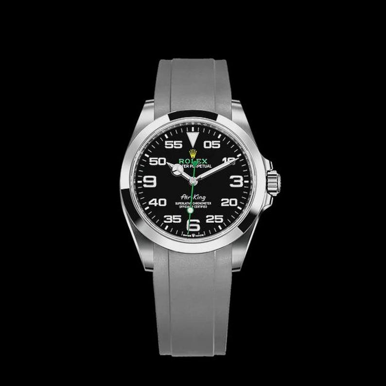 May include: A silver-toned wristwatch with a black face and a gray band. The watch face displays the brand name "ROLEX" and the words "Air King". The watch has a black bezel and a gray band. The hands are silver and green.