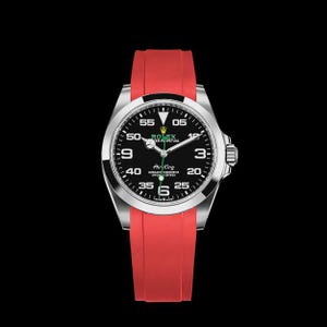 May include: A stainless steel Rolex Air King watch with a black dial and red rubber strap. The watch face features white numerals and hands, with the Rolex logo at the top. The watch is set against a black background.