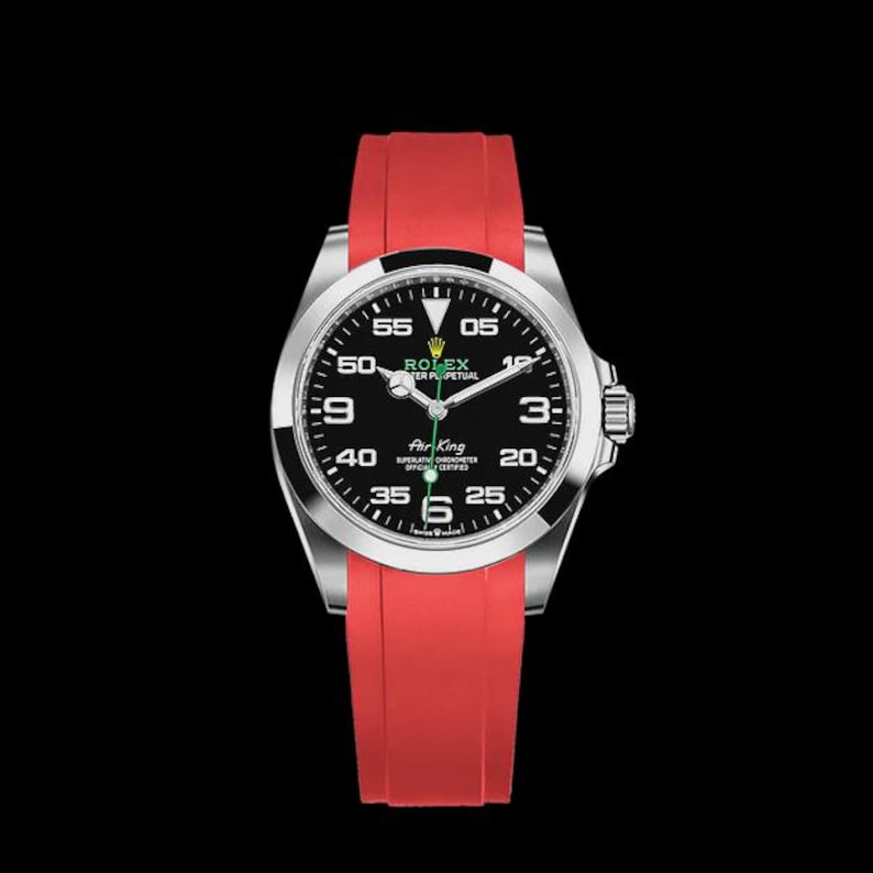 May include: A stainless steel Rolex Air King watch with a black dial and red rubber strap. The watch face features white numerals and hands, with the Rolex logo at the top. The watch is set against a black background.
