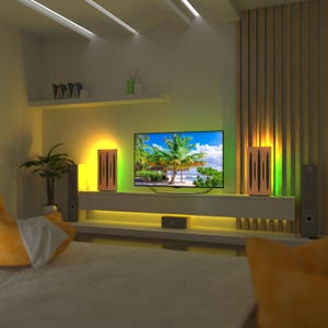 May include: A modern living room setup featuring a large flat-screen TV displaying a tropical beach scene. The room has built-in shelving, ambient lighting, and two speakers. The color scheme includes white, wood tones, and accent lighting.