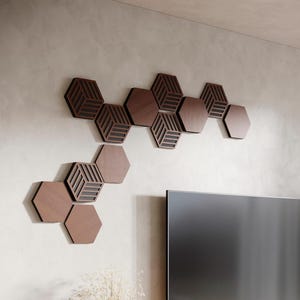May include: A wall-mounted decorative art piece made of hexagonal wooden panels. Some panels are solid, while others have a geometric, layered design. The panels are arranged in a flowing pattern, creating a modern aesthetic. The wood has a warm, brown tone.