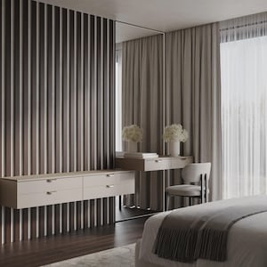 May include: A contemporary bedroom scene with a floating chest of drawers, a dressing table, and a large mirror. The room is decorated in neutral tones with wooden features and soft curtains. A bed with a grey blanket is in the foreground.