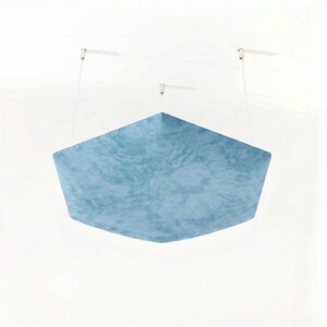 May include: A light blue, geometric, sound-dampening panel suspended from the ceiling. The panel has a textured surface and is attached by thin white cords to the ceiling. The panel's shape is a modified hexagon.