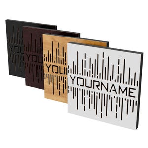 May include: Four square wooden panels with a sound wave design and the text "YOURNAME" cut out. The panels are black, dark brown, light brown, and white. The panels are for soundproofing or decoration.