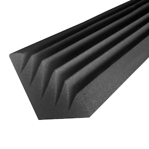 May include: A black acoustic foam panel with a wedge-shaped design. The panel has multiple ridges and is designed to absorb sound. The foam is a dark gray color and is likely used for soundproofing or acoustic treatment in a studio or home theater.