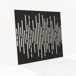 May include: A black, square decorative panel with a pattern of vertical, irregular cutouts. The cutouts vary in length and spacing, creating a dynamic visual effect. The panel is leaning against a white wall, casting a shadow.