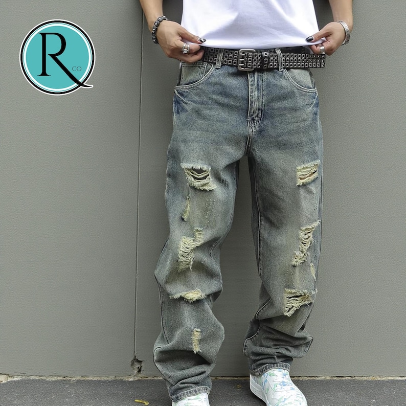Men's Ripped Denim Jeans | High Waisted Distressed Pants | Streetwear Y2k Vintage Fashion
.
A pair of men's ripped denim jeans with a relaxed, distressed design and streetwear-inspired silhouette. The jeans feature a loose fit, visible rips, and casual styling ideal for Y2K, grunge, or vintage outfits.