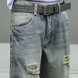 Men's Ripped Denim Jeans | High Waisted Distressed Pants | Streetwear Y2k Vintage Fashion
.
A pair of men's ripped denim jeans with a relaxed, distressed design and streetwear-inspired silhouette. The jeans feature a loose fit, visible rips, and casual styling ideal for Y2K, grunge, or vintage outfits.