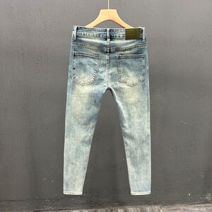 Men's Ripped Denim Jeans | High Waisted Distressed Pants | Streetwear Y2k Vintage Fashion
.
A pair of men's ripped denim jeans with a relaxed, distressed design and streetwear-inspired silhouette. The jeans feature a loose fit, visible rips, and casual styling ideal for Y2K, grunge, or vintage outfits.