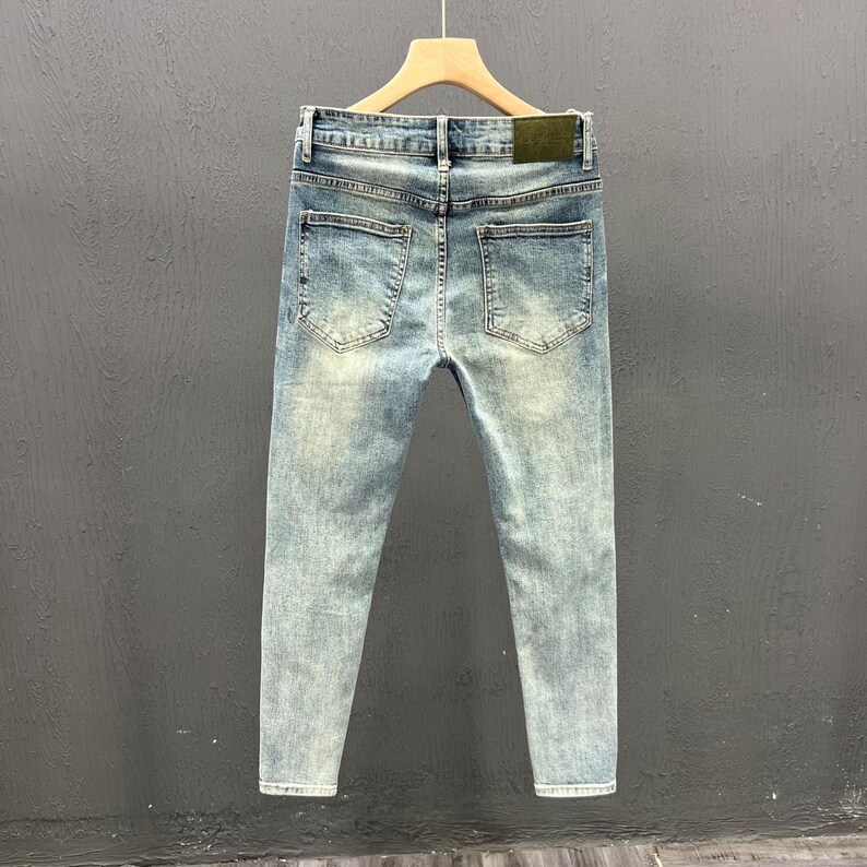 Men's Ripped Denim Jeans | High Waisted Distressed Pants | Streetwear Y2k Vintage Fashion
.
A pair of men's ripped denim jeans with a relaxed, distressed design and streetwear-inspired silhouette. The jeans feature a loose fit, visible rips, and casual styling ideal for Y2K, grunge, or vintage outfits.